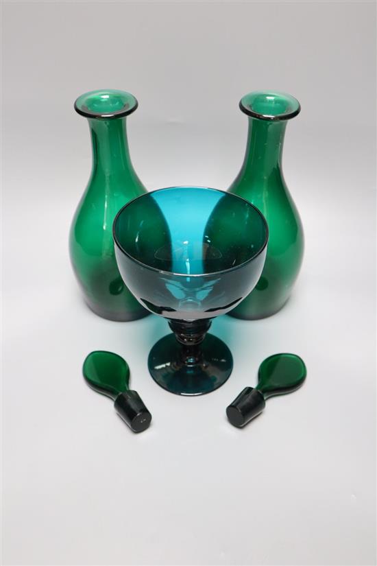 A pair of late Georgian green glass decanters and stoppers, height 27cm and a similar rummer